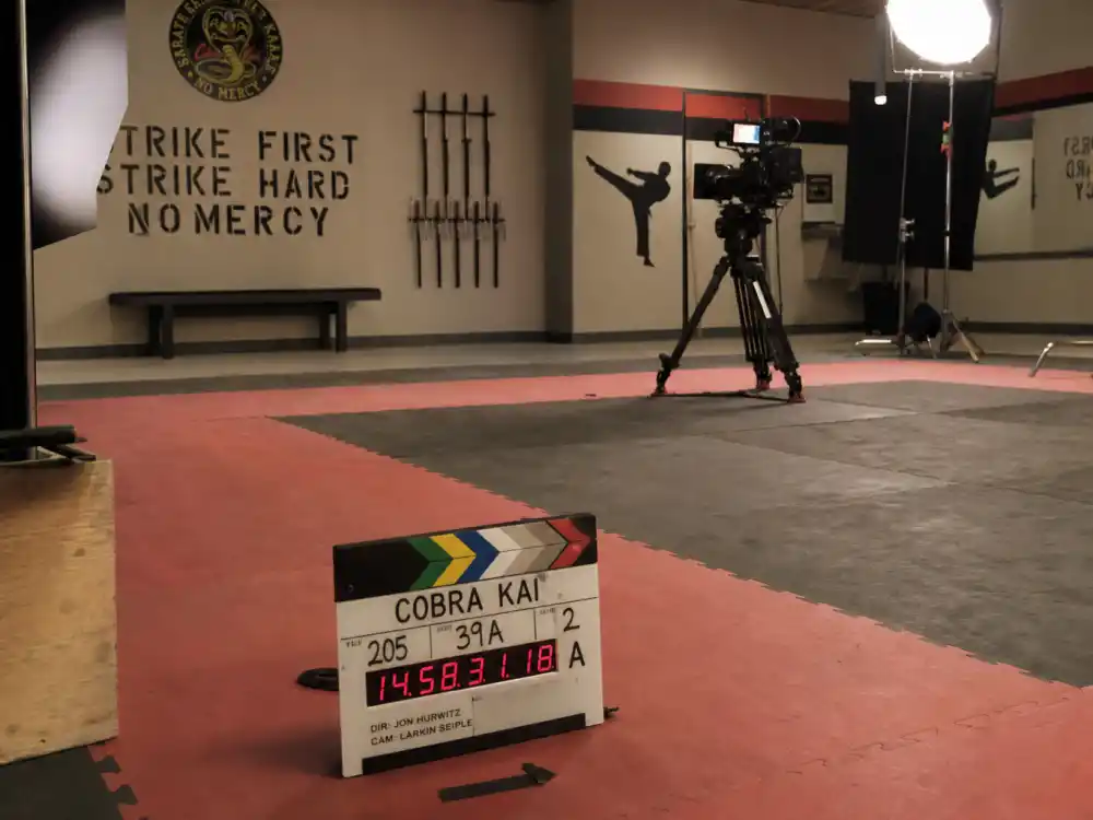 A Cobra Kai television production set with karate mats and studio lights for Ralph Macchio comeback series