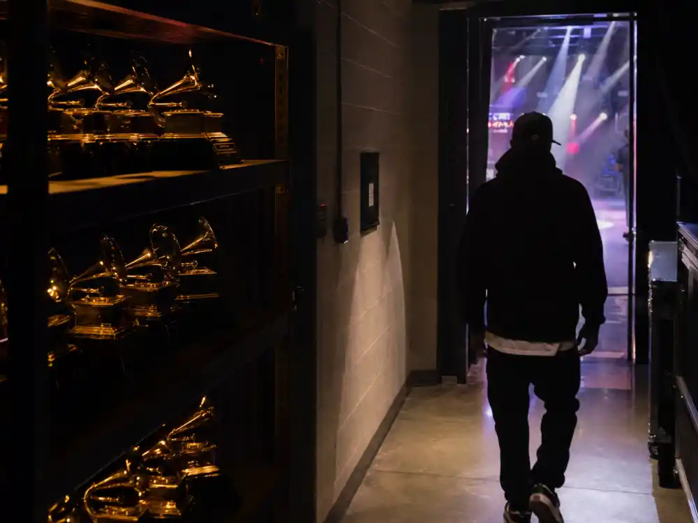Backstage awards corridor with trophy displays reflects the competitive climb among rappers with the most Grammys