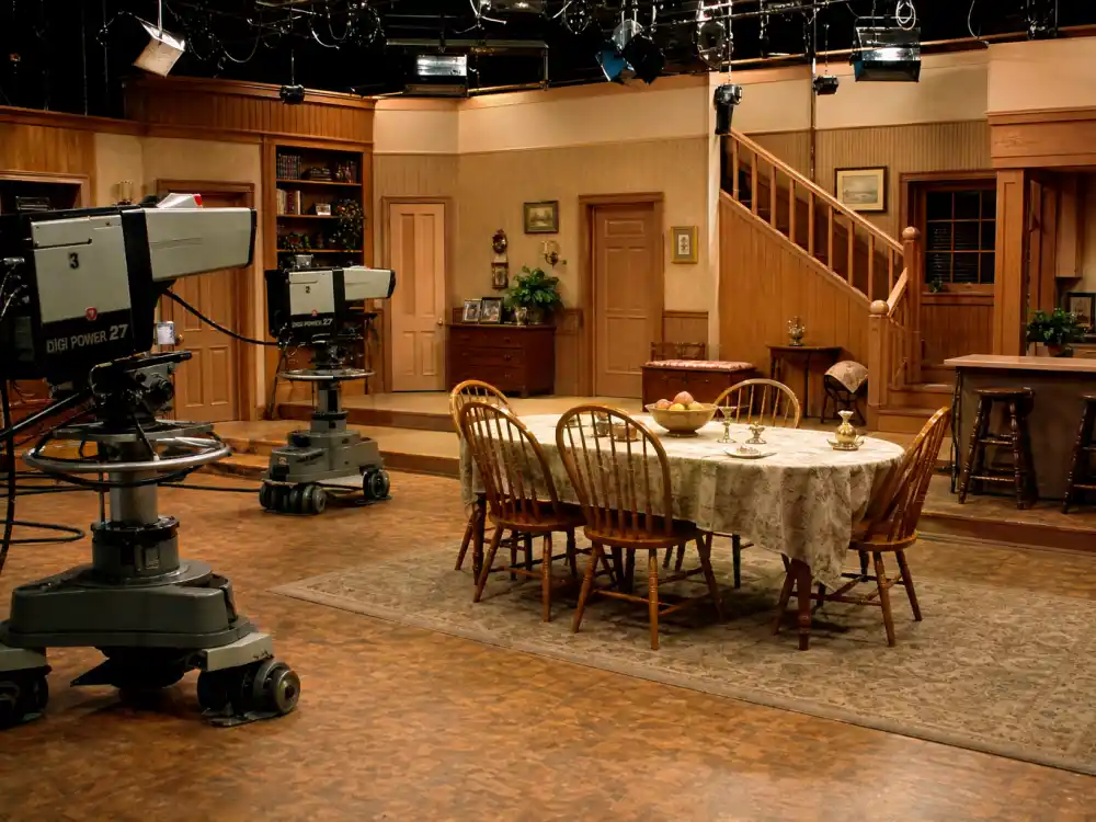 A vintage 1980s sitcom soundstage evoking Raven-Symoné as a child star on The Cosby Show