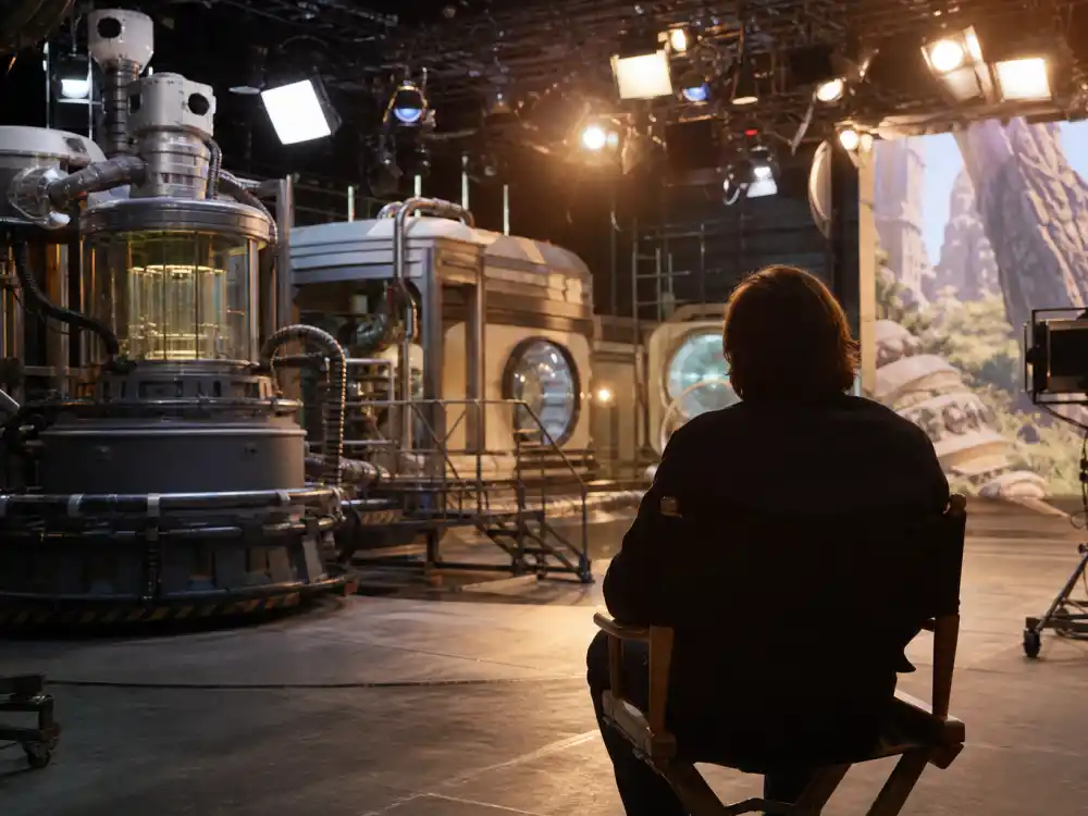 A modern sci-fi film workshop with shrink-ray props symbolizing the Rick Moranis Shrunk reboot comeback plans