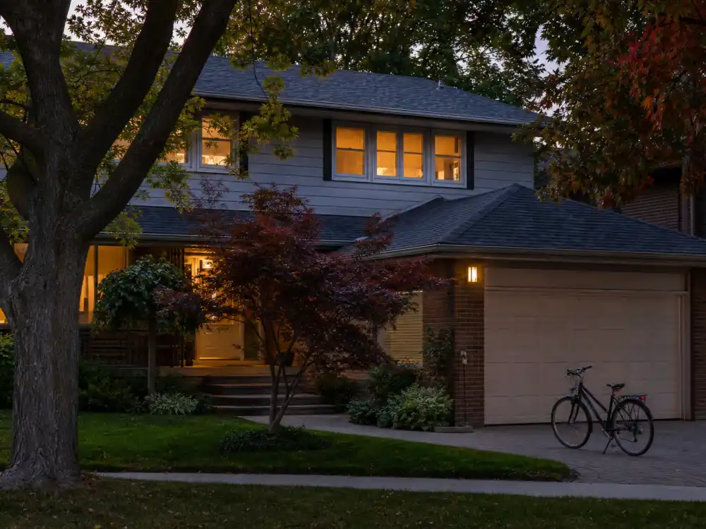 A quiet Toronto suburban home at dusk where Rick Moranis stepped away from Hollywood to raise his children