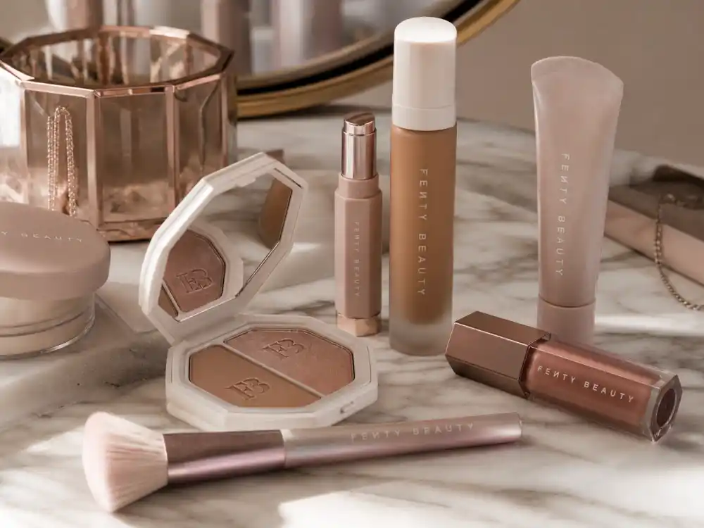 Fenty Beauty products on marble vanity reflecting Rihanna age and birthday 2026 entrepreneurship era alongside her music career milestones in her late thirties