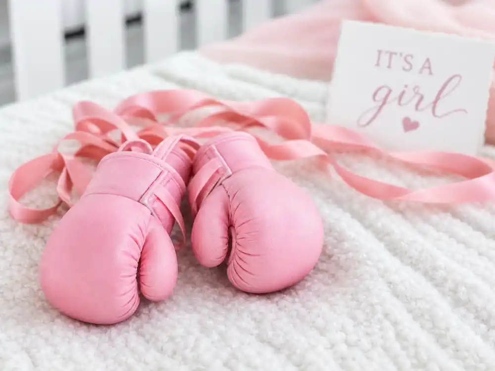 Tiny pink baby boxing gloves with ribbons for Rihanna baby third child Rocki Irish Mayers Instagram reveal detail