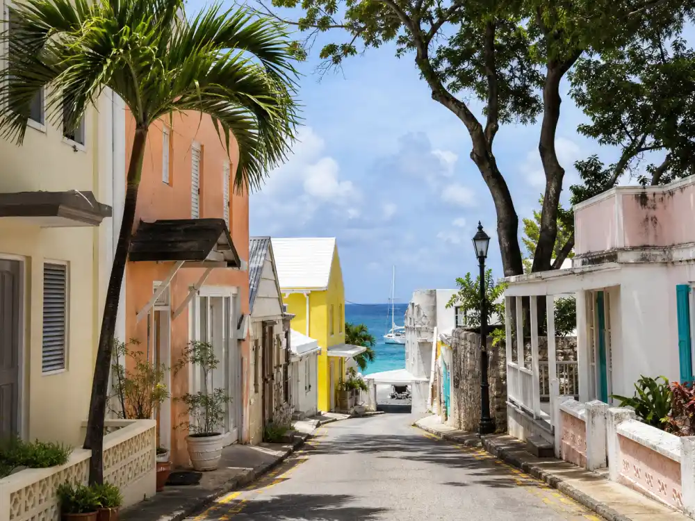 Colorful Barbados coastal village street in Rihanna family life Barbados and LA — Caribbean island roots where the Fenty founder was born in Saint Michael