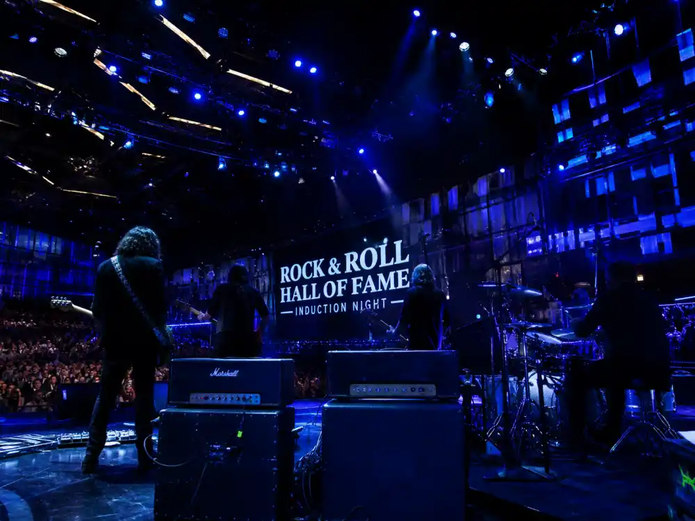 Concert stage with guitar amplifiers silhouettes for Rock and Roll Hall of Fame 2026 inductees performer category celebration night