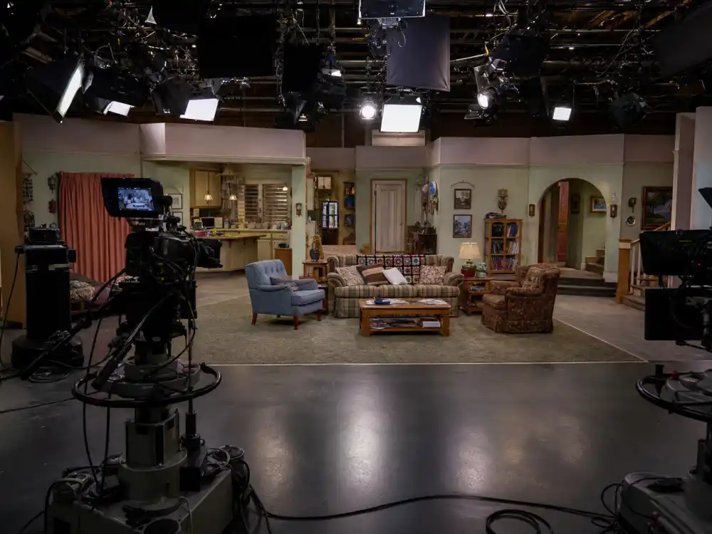 Modern sitcom soundstage representing The Conners and the Roseanne cast where are they now post-revival era