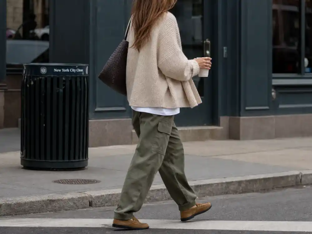 Oatmeal knit cardigan over white tee and olive cargos defining Rosie Huntington-Whiteley casual style layering contrast