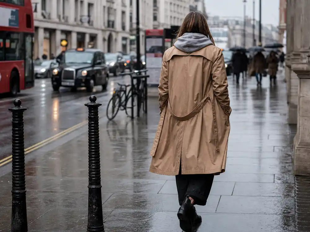 Camel trench over grey hoodie and straight jeans showing Rosie Huntington-Whiteley casual style outerwear layering formula