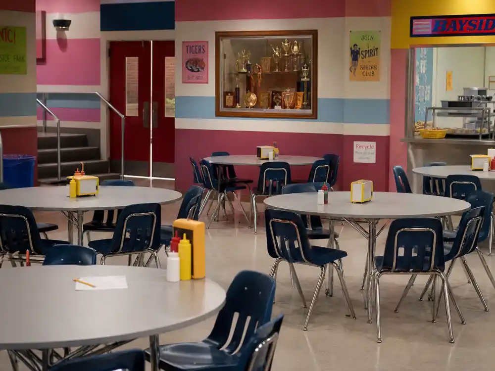 1990s high school cafeteria evoking Bayside High and the Saved by the Bell cast where are they now teen sitcom era