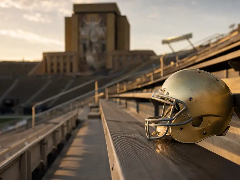 Empty football stadium bleachers at golden hour representing Sean Astin in the inspirational Rudy film