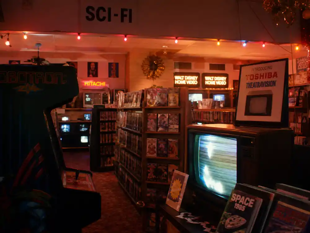 A retro 1980s electronics store with holiday lights evoking Sean Astin as Bob Newby on Stranger Things