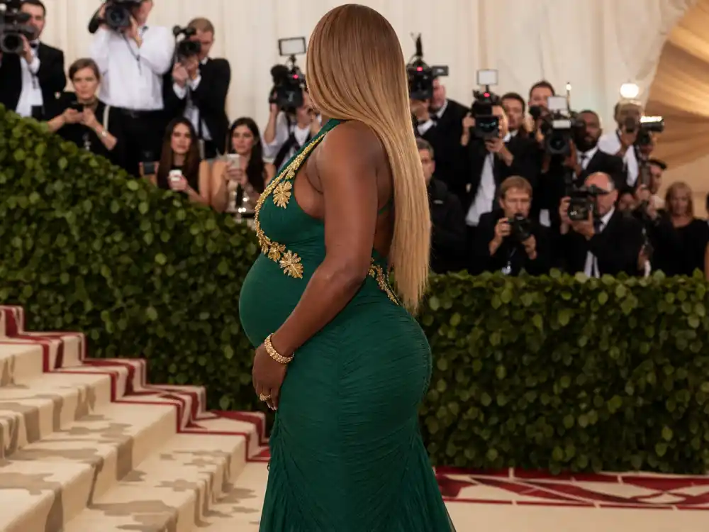 Anonymous pregnant woman in emerald green bodycon gown on Met Gala red carpet for Serena Williams maternity fashion looks formal event dressing