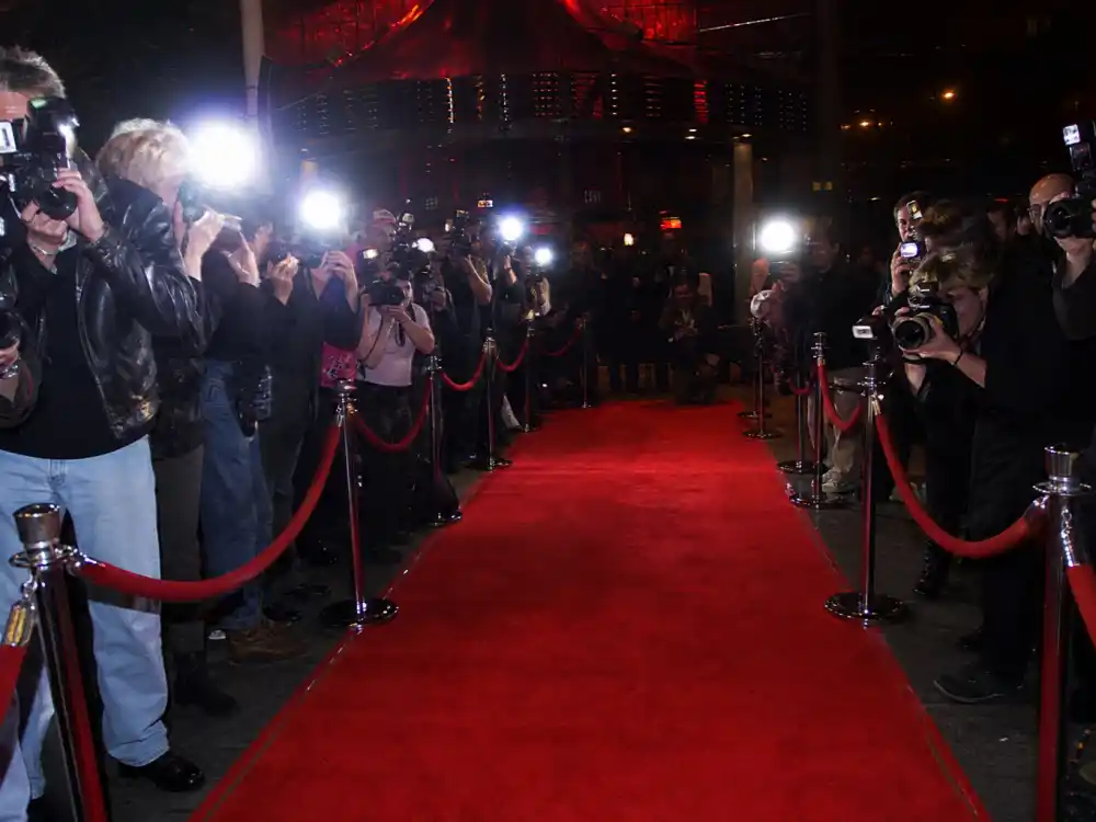 Paparazzi flash bulbs outside a Hollywood nightclub for the Tara Reid party-girl tabloid years
