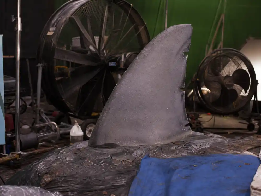 Campy disaster film workshop with a foam shark fin prop for the Tara Reid Sharknado franchise era