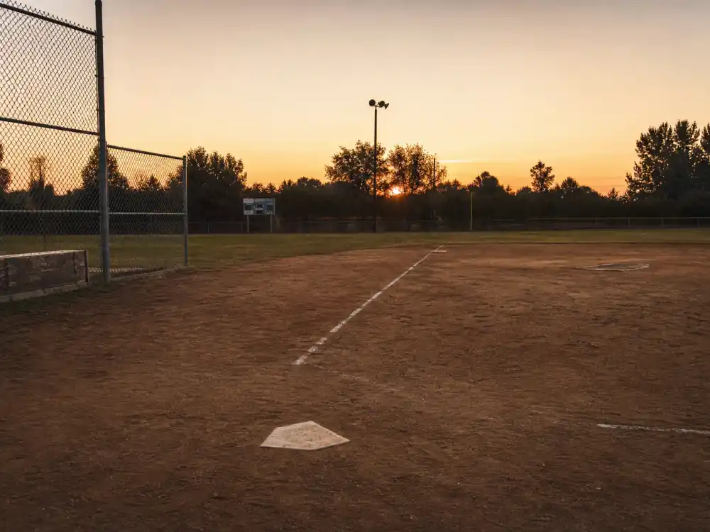 Empty 1970s Little League baseball diamond evoking Tatum O'Neal Bad News Bears child star peak