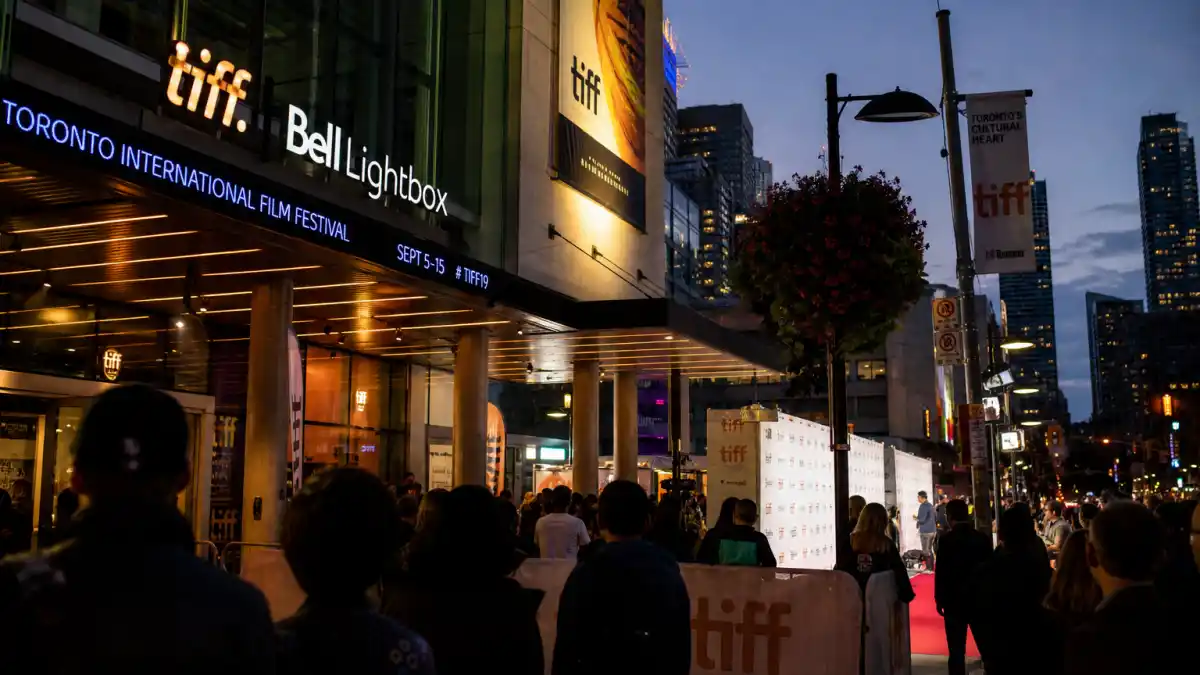 TIFF People's Choice Award winners list — TIFF Bell Lightbox festival banners and red carpet atmosphere in downtown Toronto at dusk