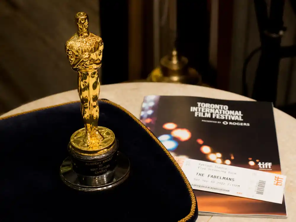 Oscar statuette beside Toronto festival program illustrating TIFF People's Choice Award winners list Oscar predictor reputation