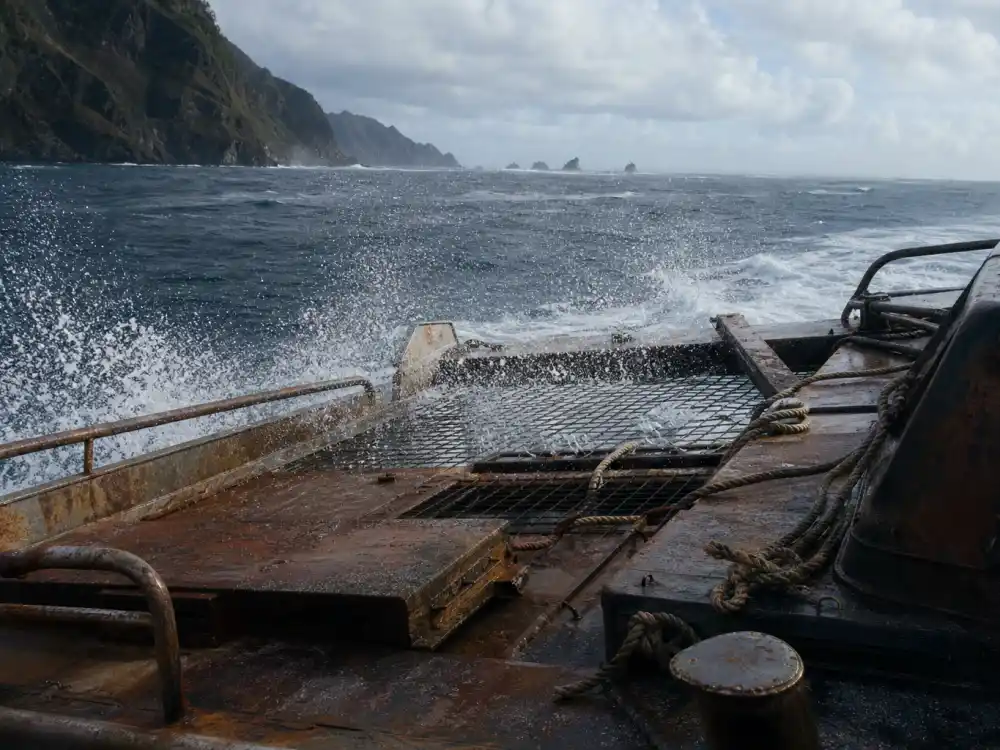 Rusted catamaran deck on open sea for Tina Majorino Waterworld blockbuster era in 1995