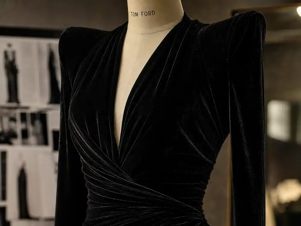 Black velvet evening gown on dress form showing liquid fabric texture that Tom Ford celebrity red carpet fans pin to Pinterest mood boards every awards season