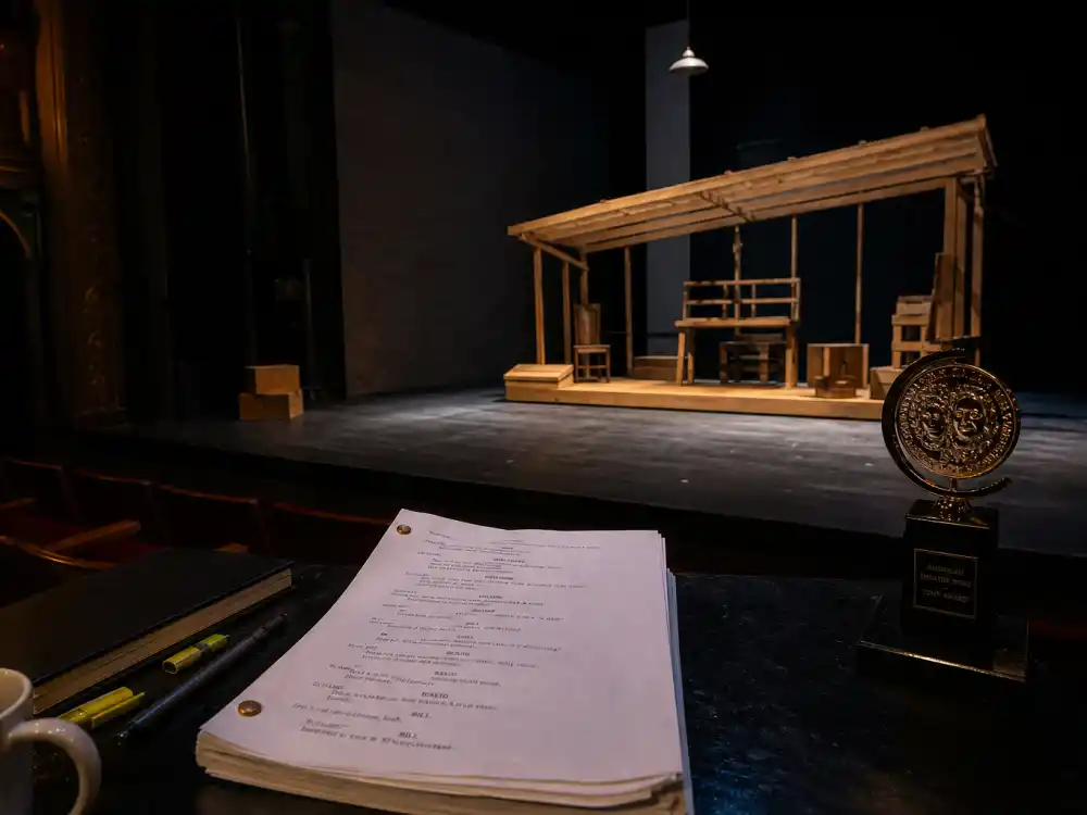 Empty Broadway play stage with script pages illustrating Best Play among Tony Awards categories explained for straight theatre productions