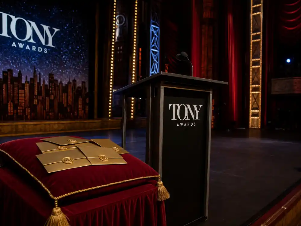 Tony Awards ceremony podium with sealed envelopes when Broadway shows with most Tony nominations lists update each June