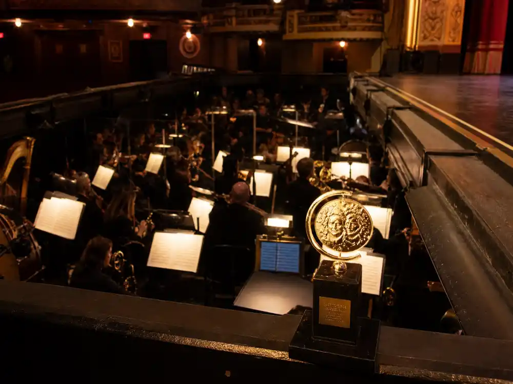 Broadway orchestra pit with Tony nomination tally cards tracking Broadway shows with most Tony nominations ceremony-night counts