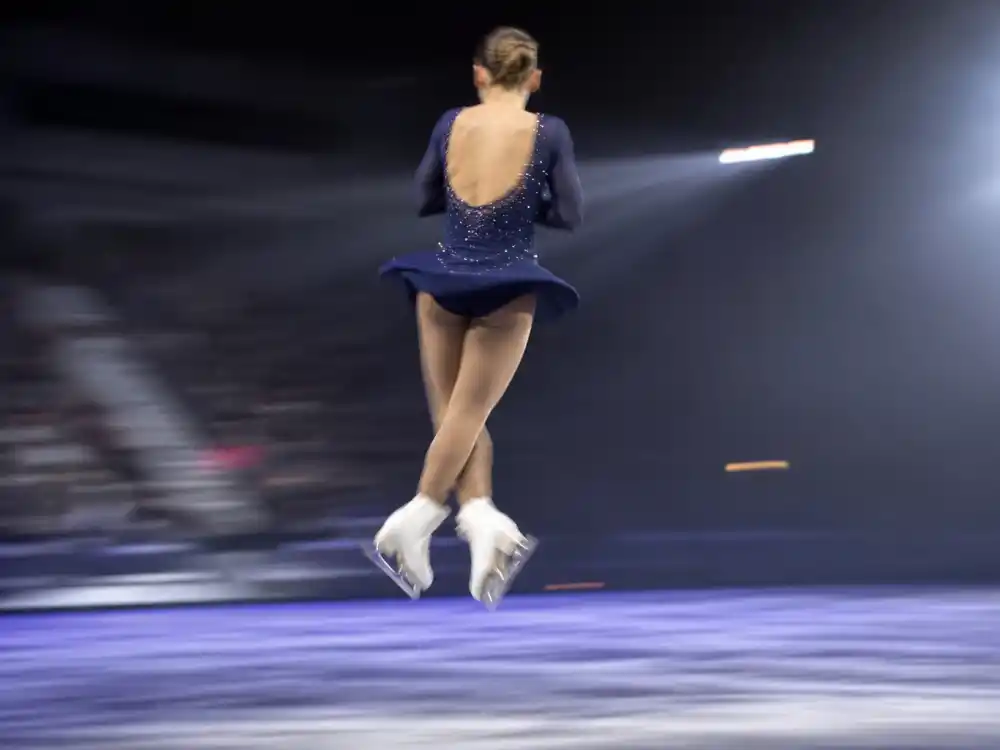 Anonymous figure skater mid-triple jump for where is Tonya Harding now triple axel pioneer legacy