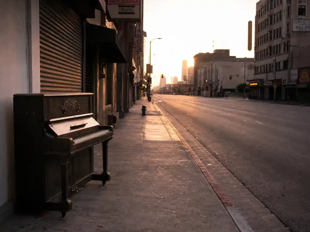 City street at dawn with upright piano evoking what happened to Vanessa Carlton during A Thousand Miles breakthrough