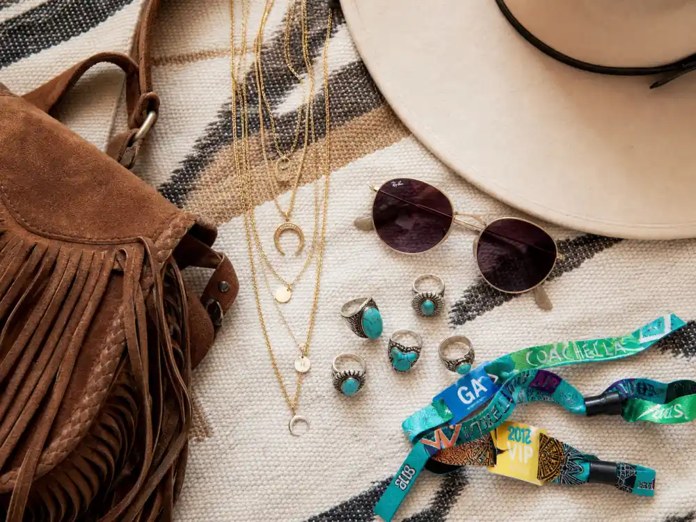 Layered gold necklaces turquoise rings and festival accessories finishing Vanessa Hudgens festival street style jewelry layer