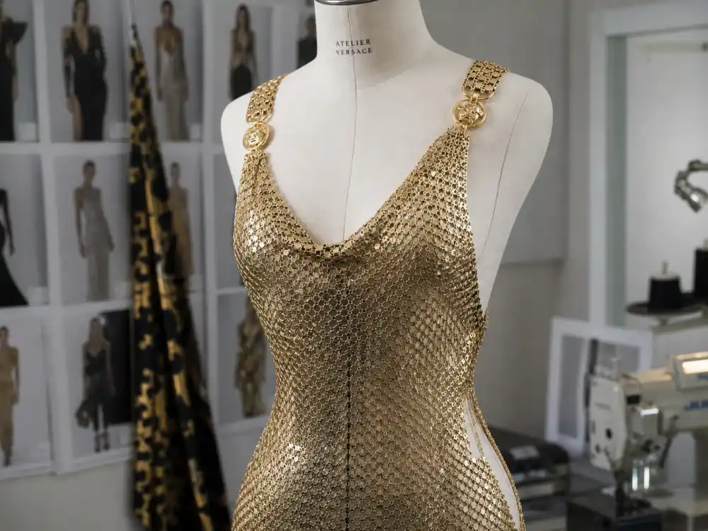 Gold chain mesh evening dress on dress form showing Versace Atelier construction celebrities choose for Versace celebrity red carpet moments at Met Gala and awards shows