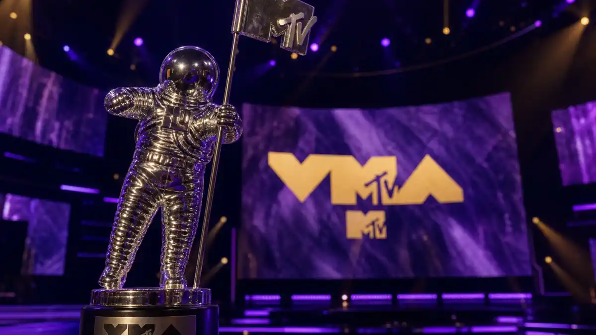 VMA Moon Person trophy history — silver astronaut statuette on MTV Video Music Awards stage with purple lighting and VMA logo screen