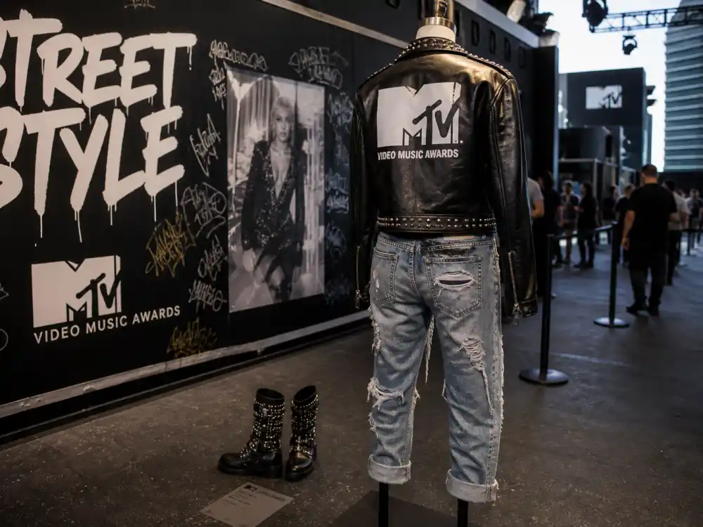 Black leather moto jacket and distressed denim on dress form from behind illustrating vmas celebrity outfits 2026 rock-and-rebel street-luxe tailoring codes