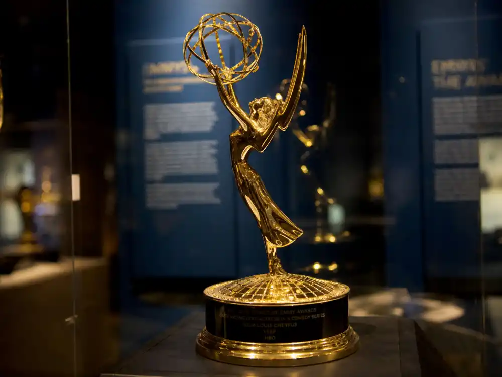 Emmy-style winged woman television award statuette in glass case for what are award trophies made of and worth materials guide