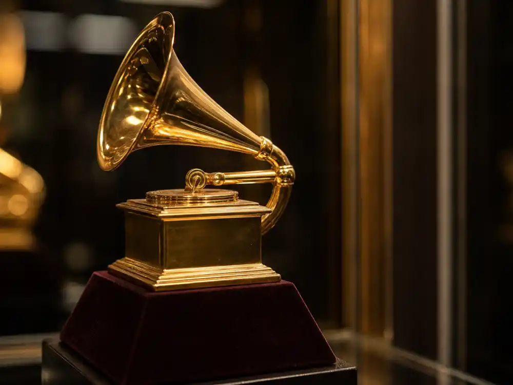 Gold gramophone music award trophy on velvet pedestal for what are award trophies made of and worth Grammy materials breakdown