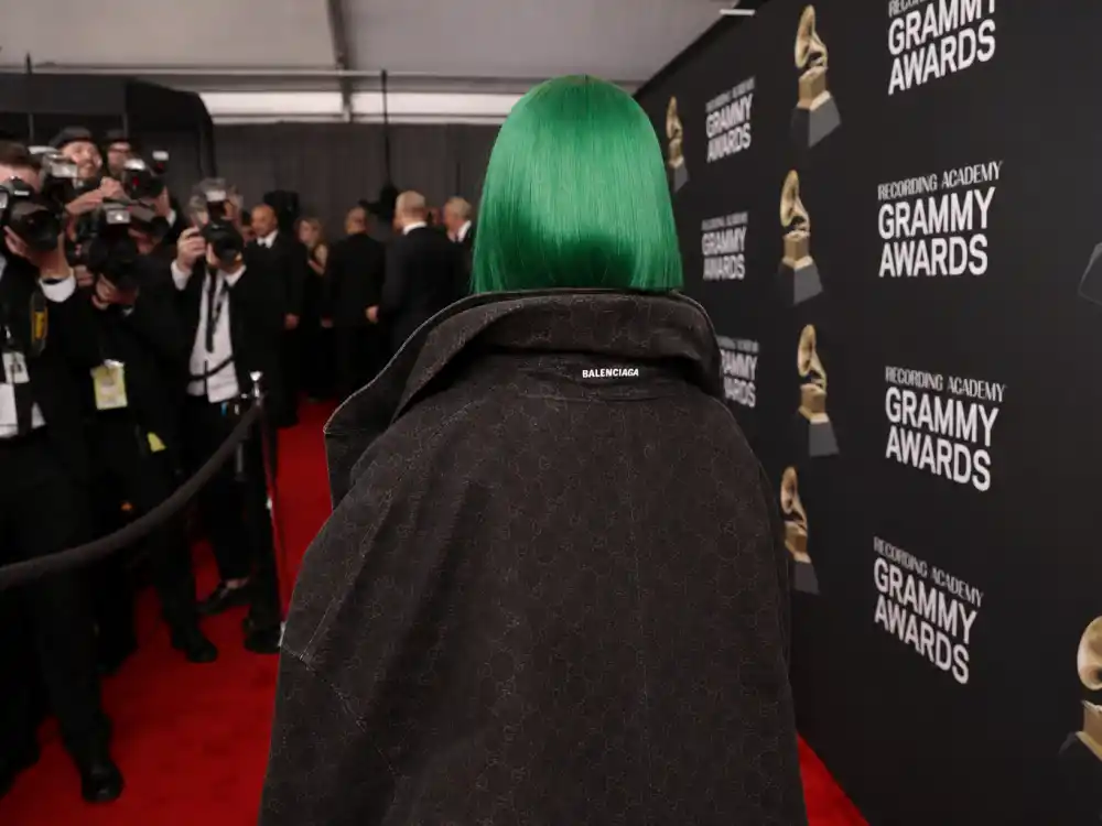 Emerald green hair era styling behind what did Billie Eilish wear to Grammys oversized streetwear phase