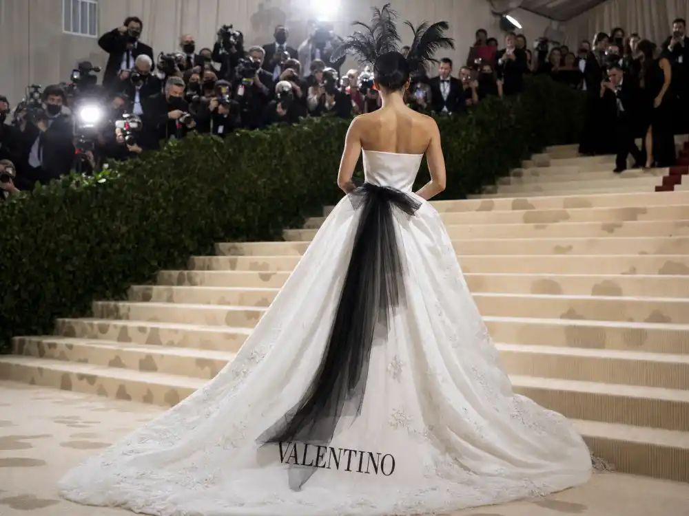 White strapless Valentino ball gown with black tulle bow defining what did Florence Pugh wear to Met Gala 2023 debut