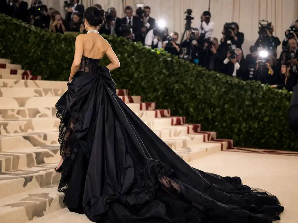 Black lace corset gown with pearl choker defining what did Gigi Hadid wear to Met Gala 2023 Givenchy naked dress trend
