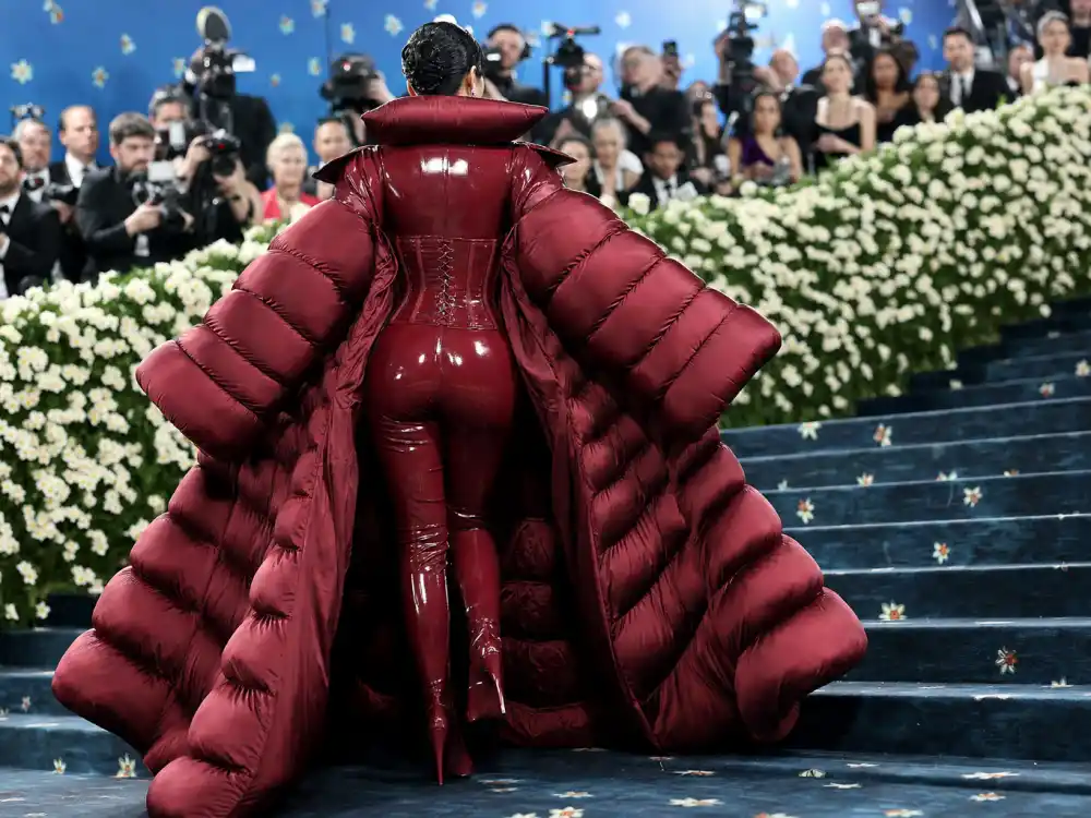 Cherry red patent latex catsuit and burgundy Versace puffer coat shaping what did Gigi Hadid wear to Met Gala 2022 gilded glamour