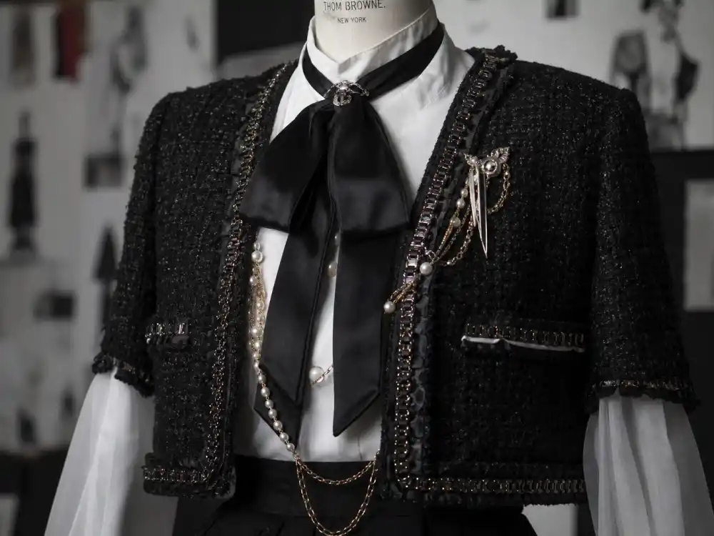 Thom Browne gothic tweed jacket and organza shirt with black ribbon bow central to what did Jenna Ortega wear to Met Gala 2023