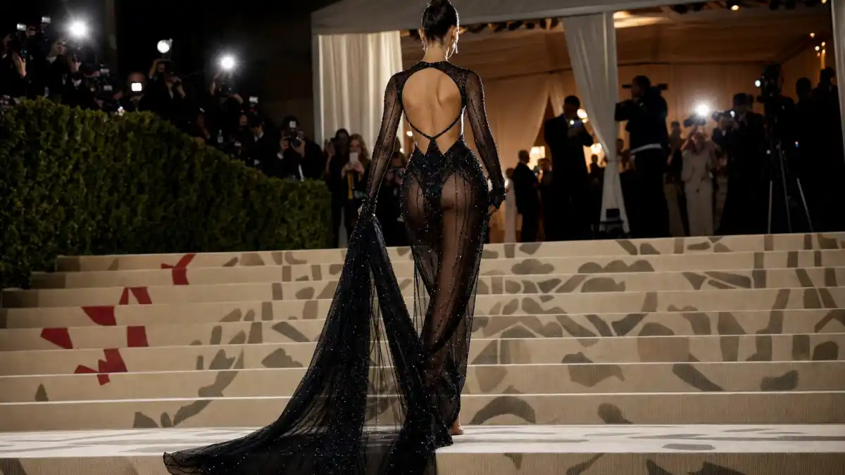 What did Kendall Jenner wear to Met Gala — sheer cutout evening gown on museum steps seen from behind with camera flashes