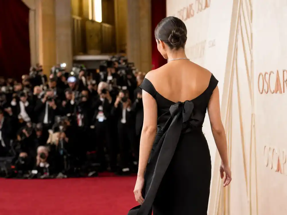 Back view of sleek black Oscar evening gown answering what did Lady Gaga wear to Oscars Hollywood glamour night