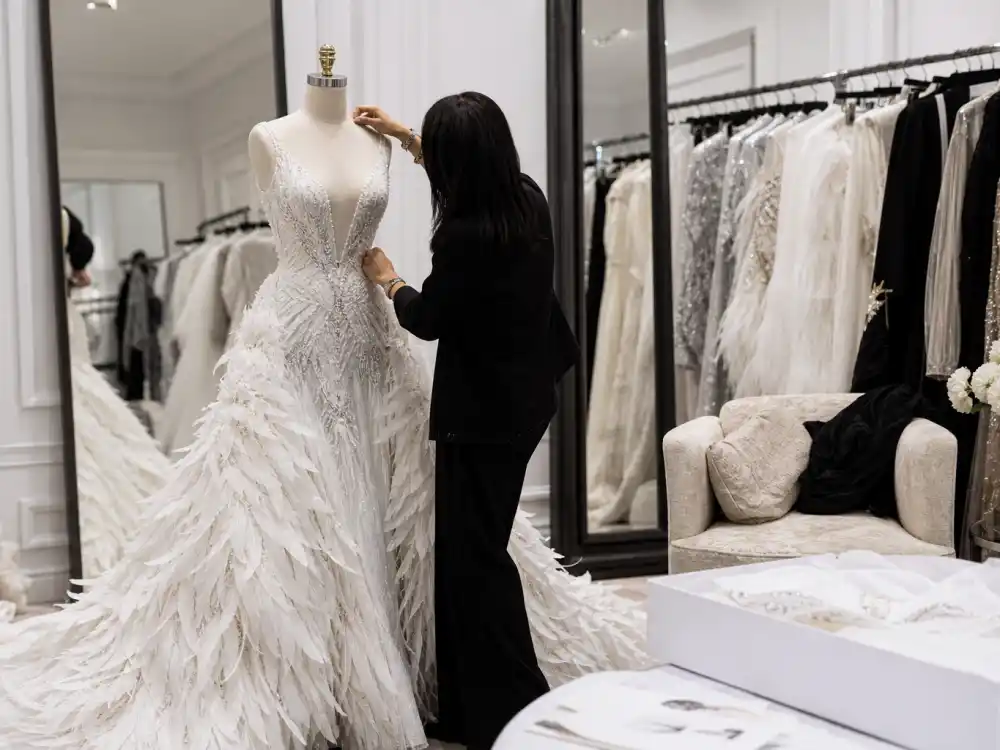 Stylist fitting dramatic couture in a dressing room before what did Rihanna wear to Met Gala red carpet arrivals