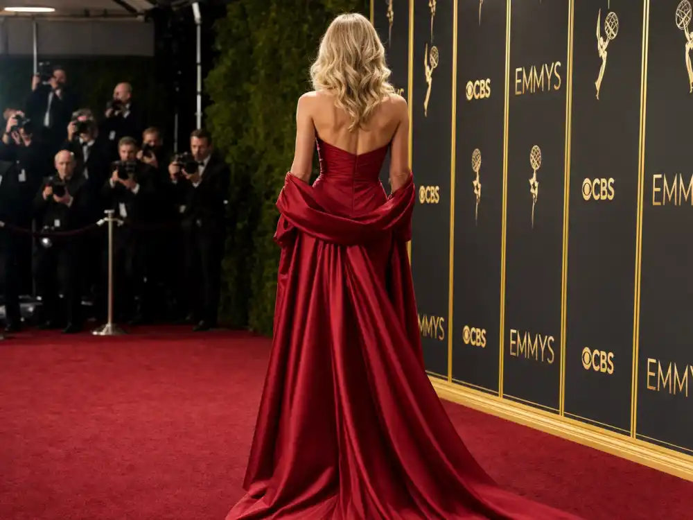 Ruby red strapless Oscar de la Renta satin gown with shawl defining what did Sydney Sweeney wear to Emmys 2025 red carpet moment