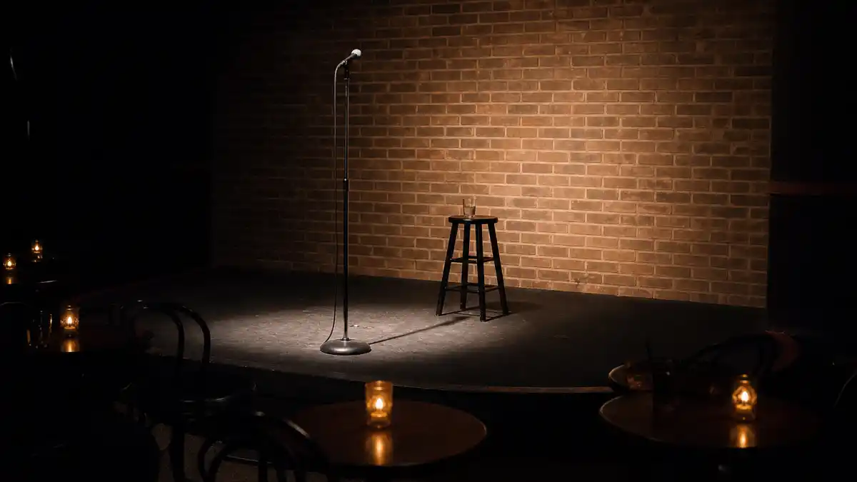 What happened to Dane Cook — empty comedy club stage spotlight evoking his stand-up superstar era