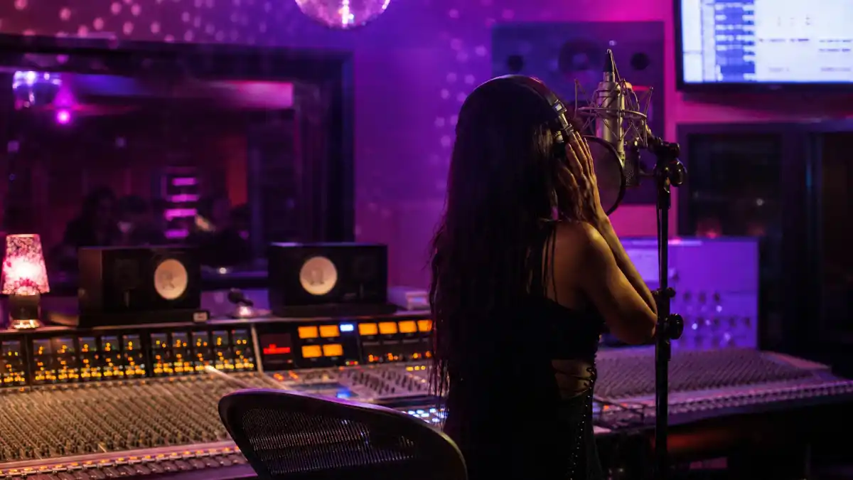 What happened to Nelly Furtado — late 2000s pop studio microphone and disco lights Promiscuous Maneater era