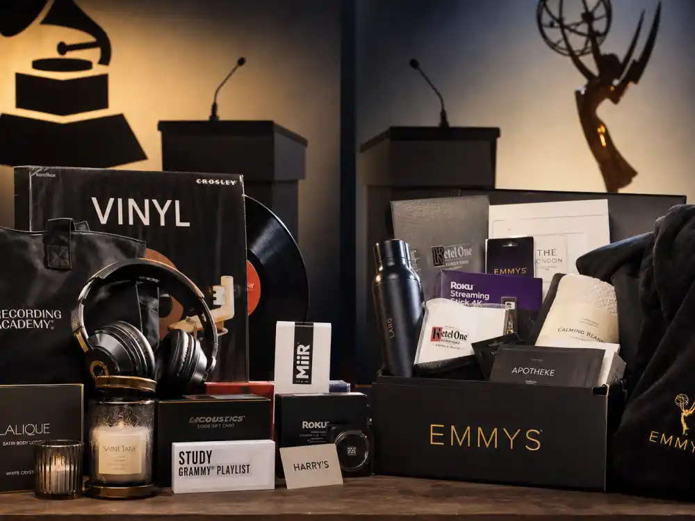 Grammy and Emmy style swag lounge display with headphones, vinyl, and TV industry gift boxes — what is in award show gift bags varies by ceremony beyond the Oscar suitcases