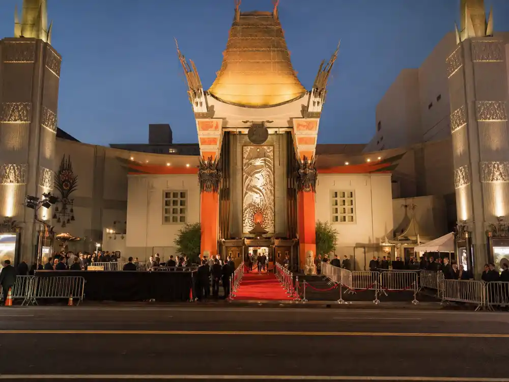 Where are the Oscars held at the Dolby Theatre — ornate Hollywood theatre exterior with red carpet and velvet ropes at dusk