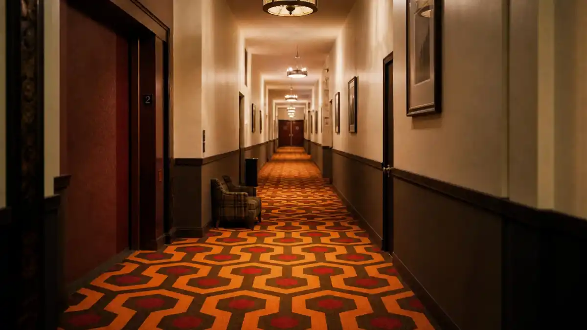 Where is Danny Lloyd now — iconic Overlook Hotel corridor carpet evoking The Shining Danny Torrance child star era