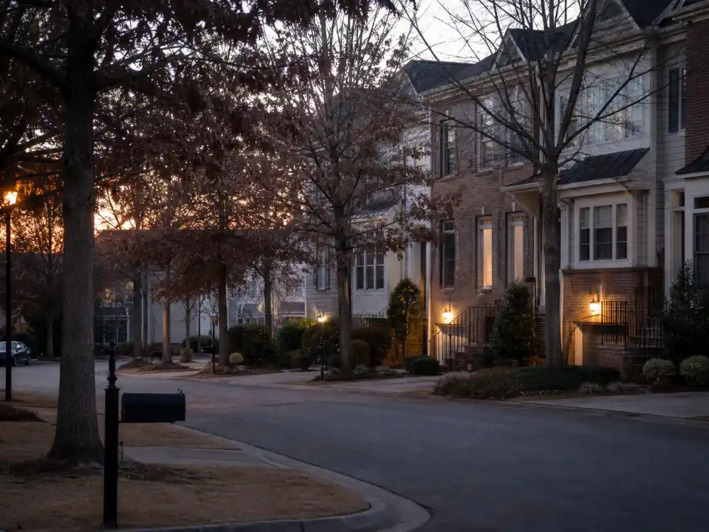 Quiet Atlanta suburban street at dusk for where is Kim Zolciak now in 2026