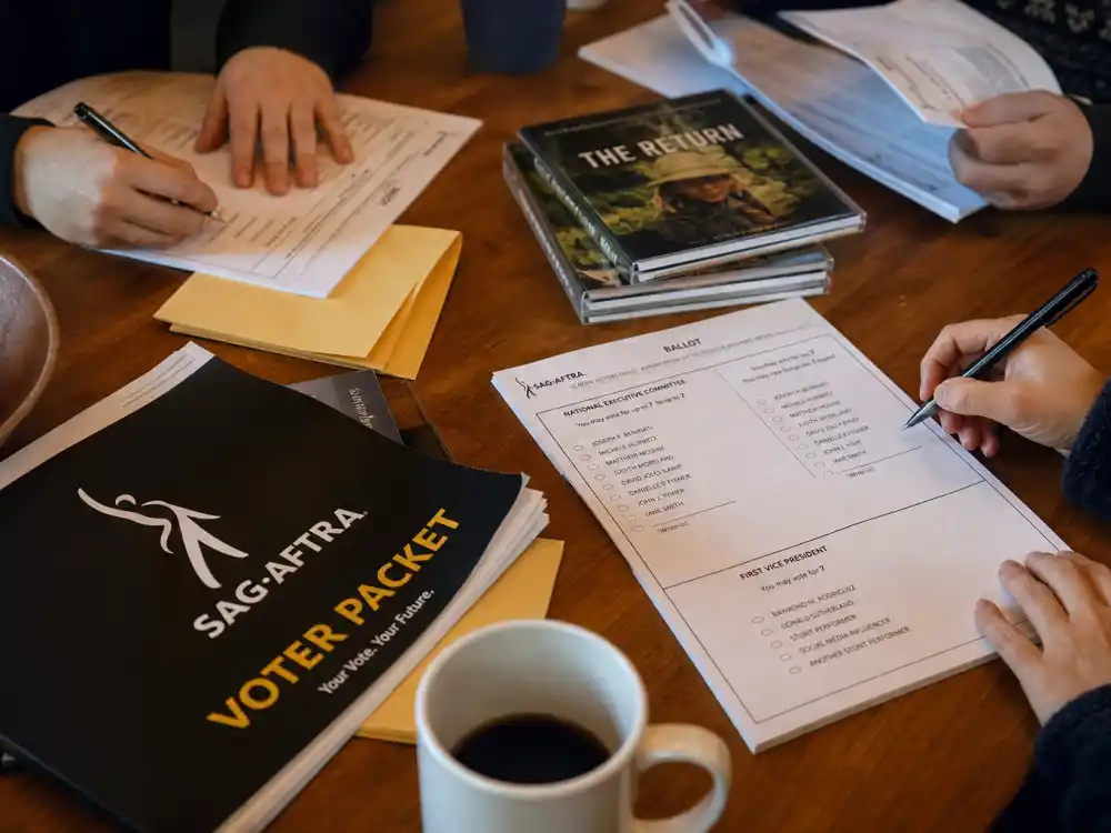 Anonymous hands marking peer ballots illustrate how who votes for the SAG Awards turns viewing into Actor Awards winners each season